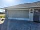 Attached garage with a large door for easy entry, next to the front door at 23176 Lindale Ave, Port Charlotte, FL 33954