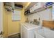 Laundry room with washer, dryer, and shelving at 23176 Lindale Ave, Port Charlotte, FL 33954