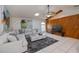 Comfortable living room with sectional sofa, large TV and wood wall at 23176 Lindale Ave, Port Charlotte, FL 33954