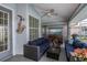 Relaxing covered patio with seating area and TV at 23176 Lindale Ave, Port Charlotte, FL 33954