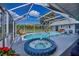 Relaxing pool and spa area with screened enclosure at 23176 Lindale Ave, Port Charlotte, FL 33954