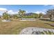 Large backyard with tropical landscaping and screened patio at 25017 Lalique Pl, Punta Gorda, FL 33950