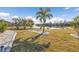 Landscaped backyard with pond and palm trees at 25017 Lalique Pl, Punta Gorda, FL 33950