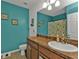 Bathroom with teal walls and a vanity with a sink at 25017 Lalique Pl, Punta Gorda, FL 33950