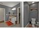 Bathroom with double vanity, separate toilet area, and walk-in closet at 25017 Lalique Pl, Punta Gorda, FL 33950