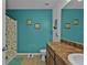 Bathroom with teal walls and double vanity at 25017 Lalique Pl, Punta Gorda, FL 33950