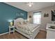 Bright bedroom with white bed frame and teal accent wall at 25017 Lalique Pl, Punta Gorda, FL 33950