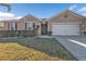 One-story home with attached garage, landscaped lawn, and a neutral color palette at 25017 Lalique Pl, Punta Gorda, FL 33950