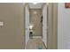 Simple hallway with neutral walls and tile flooring, leading to other rooms at 25017 Lalique Pl, Punta Gorda, FL 33950