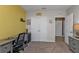 Home office with desk, chair, and access to hallway at 25017 Lalique Pl, Punta Gorda, FL 33950