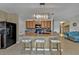 Kitchen island with granite countertop and black appliances at 25017 Lalique Pl, Punta Gorda, FL 33950