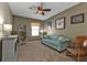Living room with teal sofa, rocking chair, and built-in shelving at 25017 Lalique Pl, Punta Gorda, FL 33950