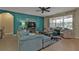 Spacious living area with teal sectional sofa and a large window at 25017 Lalique Pl, Punta Gorda, FL 33950