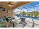 Relaxing screened-in pool area with patio furniture at 25017 Lalique Pl, Punta Gorda, FL 33950