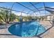 Relaxing kidney-shaped pool with screened enclosure at 25017 Lalique Pl, Punta Gorda, FL 33950