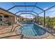 Enclosed kidney-shaped pool in a sunny backyard at 25017 Lalique Pl, Punta Gorda, FL 33950