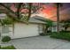 Two-car garage with paver driveway and lush landscaping at 251 Viceroy Ter, Port Charlotte, FL 33954