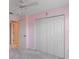 Pink bedroom with double-door closet and ceiling fan at 2606 Trilby Ave, North Port, FL 34286