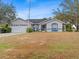 Single-story house with a two-car garage and a well-maintained lawn at 2606 Trilby Ave, North Port, FL 34286