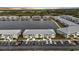 Aerial view of community with lake and multiple buildings at dusk at 3310 Loveland Blvd # 701, Punta Gorda, FL 33980