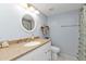 Bathroom with white vanity, shower, and seashell decor at 3310 Loveland Blvd # 701, Punta Gorda, FL 33980