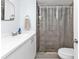 Bathroom featuring a white vanity, walk-in shower, and toilet at 3310 Loveland Blvd # 701, Punta Gorda, FL 33980