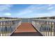 Brown wood community dock with white railings and lake views at 3310 Loveland Blvd # 701, Punta Gorda, FL 33980