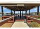 Lakefront gazebo with wooden deck and seating at 3310 Loveland Blvd # 701, Punta Gorda, FL 33980