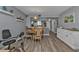 Bright dining area with a round table and four chairs, an exercise bike and view into kitchen at 3310 Loveland Blvd # 701, Punta Gorda, FL 33980