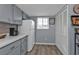 Condo kitchen with gray cabinets and white appliances at 3310 Loveland Blvd # 701, Punta Gorda, FL 33980