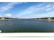 Community lakefront view, serene waterfront property with lush landscaping at 3310 Loveland Blvd # 701, Punta Gorda, FL 33980
