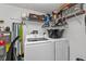 Bright laundry room with washer, dryer, and ample storage shelving at 3310 Loveland Blvd # 701, Punta Gorda, FL 33980