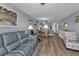 Relaxing living room featuring a gray couch and comfortable armchair at 3310 Loveland Blvd # 701, Punta Gorda, FL 33980