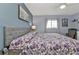 King-size bed with floral bedding in spacious main bedroom at 3310 Loveland Blvd # 701, Punta Gorda, FL 33980