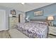 Main bedroom with king-size bed and floral bedding, dresser and ensuite bathroom at 3310 Loveland Blvd # 701, Punta Gorda, FL 33980