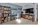 Home office with built-in bookcase, desk, and TV at 3310 Loveland Blvd # 701, Punta Gorda, FL 33980