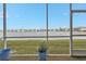 Spacious screened porch with lake view and two comfy chairs at 3310 Loveland Blvd # 701, Punta Gorda, FL 33980