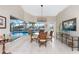 Breakfast nook with glass table and wicker chairs overlooking the pool at 3406 Saint Croix Ct, Punta Gorda, FL 33950