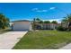 Single-story home with attached garage and lush lawn at 414 Norma Ct, Punta Gorda, FL 33950