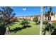 Landscaped courtyard with manicured lawns and palm trees at 1 Colony Point Dr # 3C, Punta Gorda, FL 33950