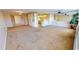 Open living room and kitchen with carpeted floor at 1 Colony Point Dr # C3, Punta Gorda, FL 33950