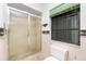 Bathroom showcases a glass-enclosed shower and a dark-framed window at 10129 Edmonton Ave, Englewood, FL 34224