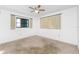 Simple bedroom with neutral carpeting, a ceiling fan, and a window with curtains at 10129 Edmonton Ave, Englewood, FL 34224