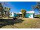 A single-story home displays a well-kept lawn and vibrant tropical foliage at 10129 Edmonton Ave, Englewood, FL 34224