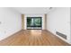 Bright living room with wood floors and sliding glass doors leading to the outdoor area at 10129 Edmonton Ave, Englewood, FL 34224