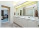 Double vanity bathroom with a view into the bedroom at 1110 Rum Cay Ct, Punta Gorda, FL 33950