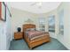 Bright bedroom with wood bed frame, carpet flooring, and large windows at 1110 Rum Cay Ct, Punta Gorda, FL 33950