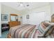 Bedroom with wood dresser, striped bedding, and sliding door closet at 1110 Rum Cay Ct, Punta Gorda, FL 33950