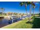 Private boat dock on a calm canal with tropical landscaping at 1110 Rum Cay Ct, Punta Gorda, FL 33950