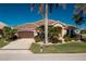 One-story home with brown garage door and lush landscaping at 1110 Rum Cay Ct, Punta Gorda, FL 33950